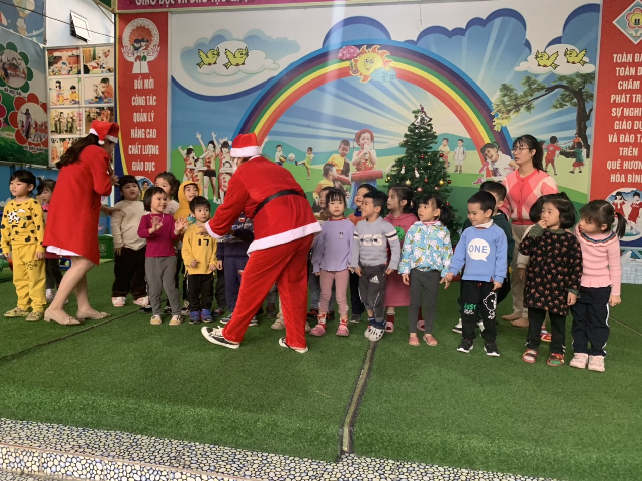 Ông già Noel đang phát quà cho các bé Trường mầm non Tân Thịnh A, tp. Hòa Bình
