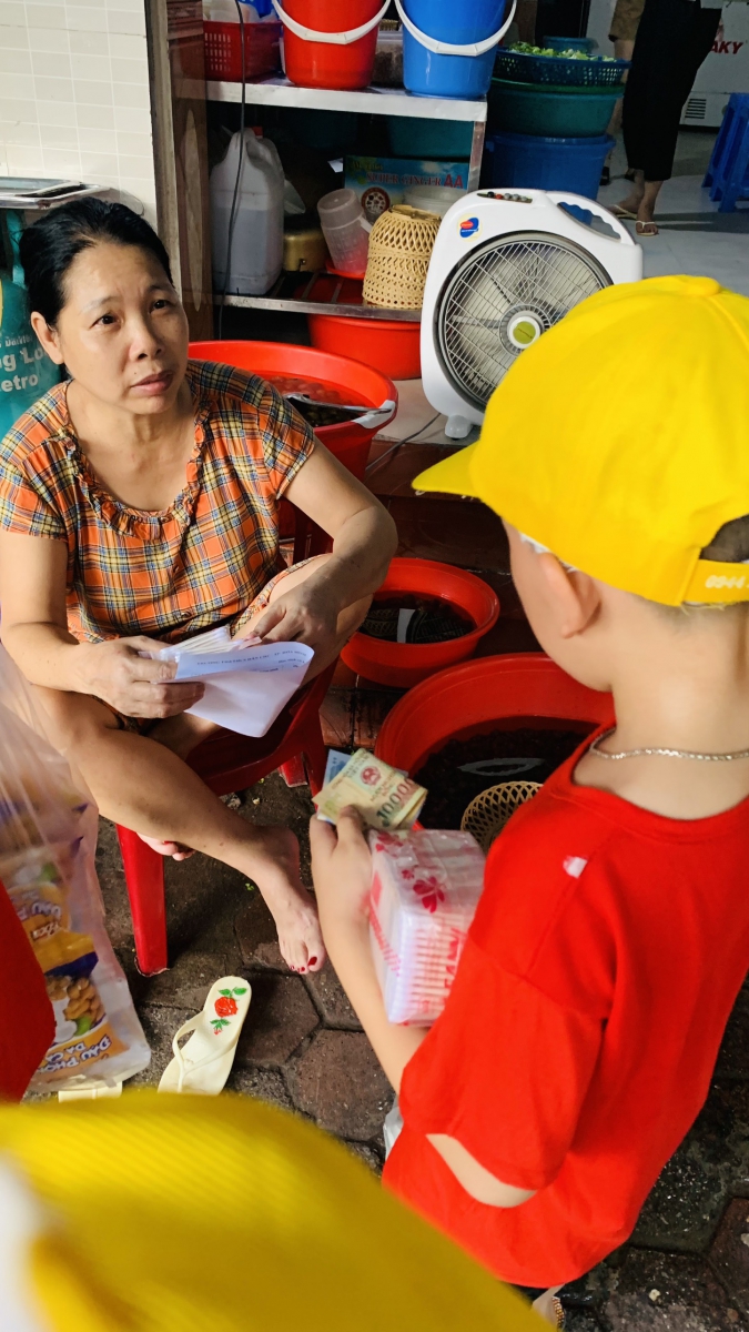 Các bạn học sinh đang giới thiệu sản phẩm cho mọi người xung quanh.